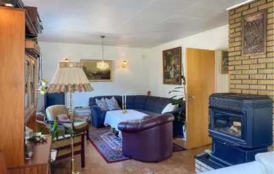 a living room with a couch and a fireplace at 4 Bedroom Gorgeous Home In Valldal in Valldal