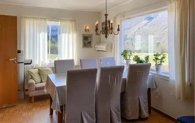 a dining room with a table and chairs and a window at 4 Bedroom Gorgeous Home In Valldal in Valldal