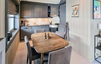 a kitchen with a wooden table and chairs at 2 Bedroom Stunning Home In Geilo in Geilo