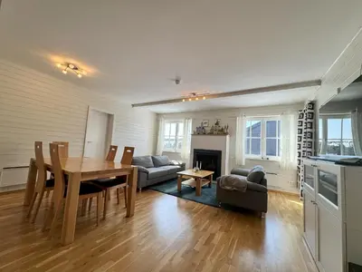 a kitchen and living room with a table and a couch at Family-friendly apartment for rent at Golsfjellet in Golsfjellet