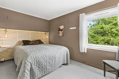 a bedroom with a bed and a window at Engbu in Vågbø