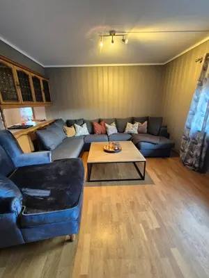 a living room with a blue couch and a coffee table at Geilo Hytter & Camping in Geilo