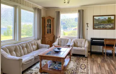 a living room with two couches and a piano at Cozy Home In Austefjorden With Wifi in Austefjorden
