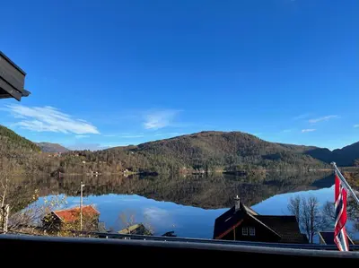 a view of a lake with mountains in the background at Cozy cabin with a view in Kvamseter