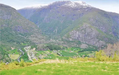 a view of a mountain range with a town in the valley at 4 Bedroom Nice Home In Eidfjord in Eidfjord