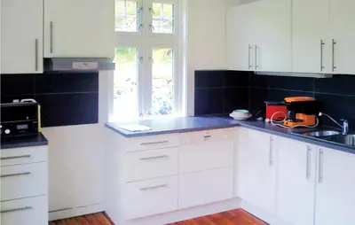 a kitchen with white cabinets and a blue counter top at 4 Bedroom Nice Home In Eidfjord in Eidfjord