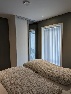 a bedroom with a bed and a large window at Flotun in Stryn