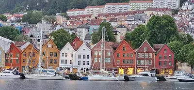 a group of boats docked in the water near a city at Dreggsalmenning 20 in Bergen