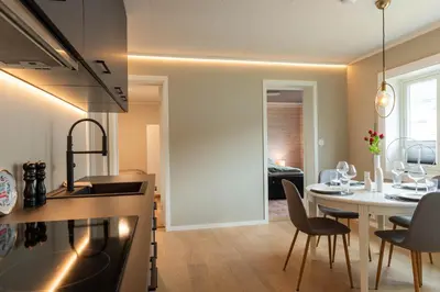 a kitchen and dining room with a table and chairs at Huset på Plassen in Sogndal
