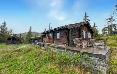 a log cabin in the woods on a hill at Awesome Home In Aurdal With Sauna in Aurdal