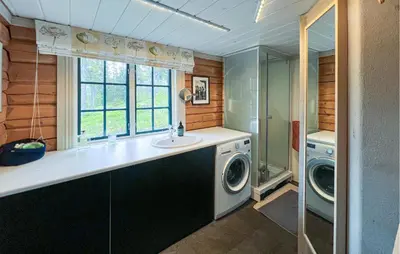 a bathroom with a sink and a washing machine at Awesome Home In Aurdal With Sauna in Aurdal