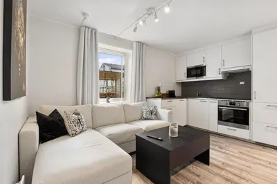 a living room with a couch and a table at Pergola - Free parking - 5 min walk to facilities in Bergen