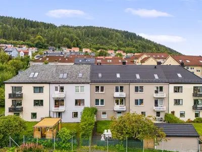a group of buildings with a mountain in the background at Pergola - Free parking - 5 min walk to facilities in Bergen