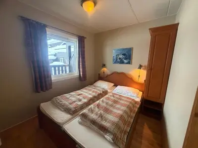 a bedroom with a bed and a window at Charming Ground-Floor Apartment In Beitostølen With Terrace in Beitostøl