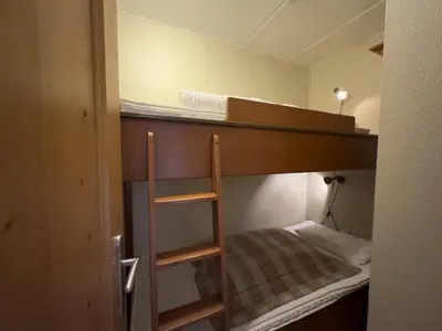 a small room with a bunk bed with a ladder at Charming Ground-Floor Apartment In Beitostølen With Terrace in Beitostøl