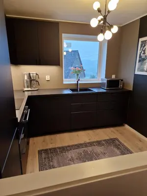 a kitchen with a sink and a window at Eidsvåg in Bergen