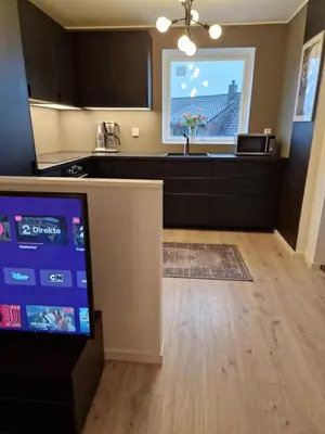 a kitchen with a counter and a large window at Eidsvåg in Bergen