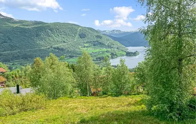 a view of a lake from a hill with trees at 3 Bedroom Stunning Home In Vossestrand in Vossestrand