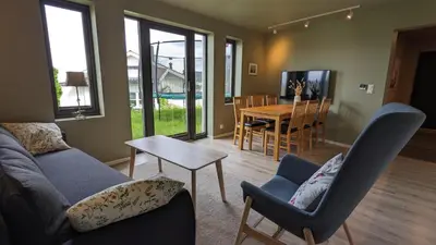 a living room with a couch and chairs and a table at New and fresh apartment, free parking and ocean view in Trondheim