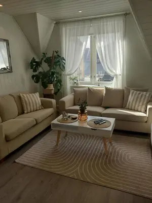 a living room with a couch and a coffee table at Light terrace city apartment Alesund in Ålesund