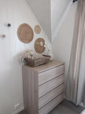 a room with a dresser and baskets on the wall at Light terrace city apartment Alesund in Ålesund