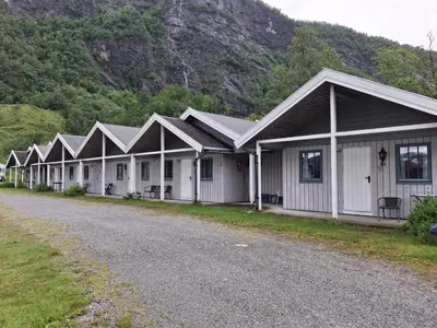 a row of houses on the side of a road at Kvanndal Camping in Kvanndal