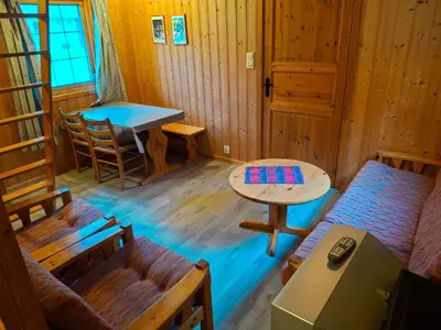 a room with a couch and a table in a cabin at Kvanndal Camping in Kvanndal