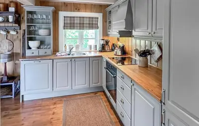 a kitchen with white cabinets and a wooden floor at 4 Bedroom Cozy Home In Gol in Golsfjellet