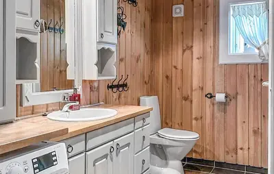 a bathroom with a white toilet and a sink at 4 Bedroom Cozy Home In Gol in Golsfjellet