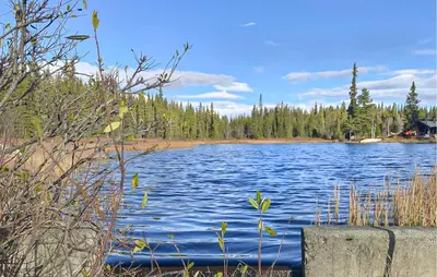 a large blue lake with trees in the background at 4 Bedroom Cozy Home In Gol in Golsfjellet