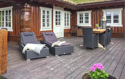a patio with chairs and a table on a deck at 4 Bedroom Cozy Home In Gol in Golsfjellet