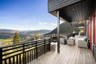 a balcony of a house with a view of the mountains at Voss Resort self-catered apartments in Skulestadmo