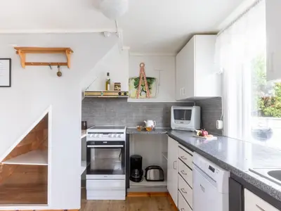 a kitchen with white cabinets and a counter top at Holiday Home Soltun by Interhome in Flygansvær