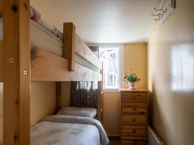 a bedroom with two bunk beds and a dresser at Holiday Home Soltun by Interhome in Flygansvær
