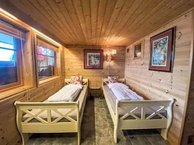 a room with two beds in a wooden cabin at Holiday Home Strand by Interhome in Vassenden