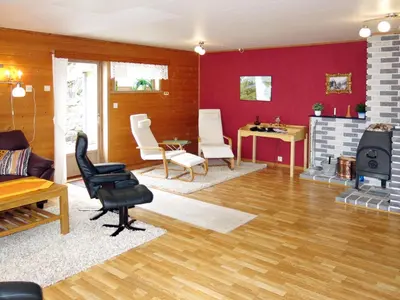 a living room with red walls and a fireplace at Holiday Home Hovsfjellet by Interhome in Fresvik