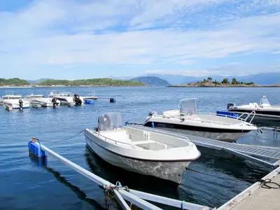 two boats are docked at a dock in the water at Holiday Home Greenhouse by Interhome in Onarheim