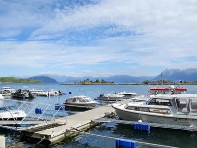 a group of boats docked at a dock in the water at Holiday Home Greenhouse by Interhome in Onarheim
