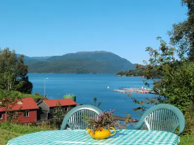 a table and chairs with a view of a lake at Holiday Home Nystølen by Interhome in Håvik