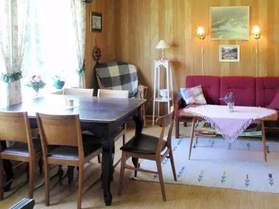 a living room with a table and chairs and a couch at Holiday Home Nystølen by Interhome in Håvik