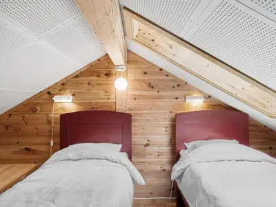 two beds in a room with wooden walls at Holiday Home Veganeset II by Interhome in Balestrand