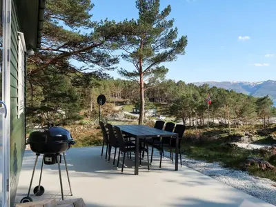 a table and chairs and a grill on a patio at Holiday Home Blåsenberg by Interhome in Bø