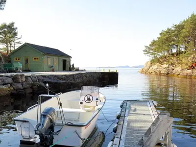 a boat is docked at a dock in the water at Holiday Home Blåsenberg by Interhome in Bø