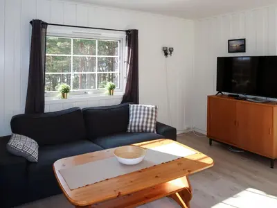 a living room with a couch and a coffee table at Holiday Home Blåsenberg by Interhome in Bø