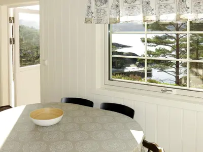 a dining room with a table and a window at Holiday Home Blåsenberg by Interhome in Bø