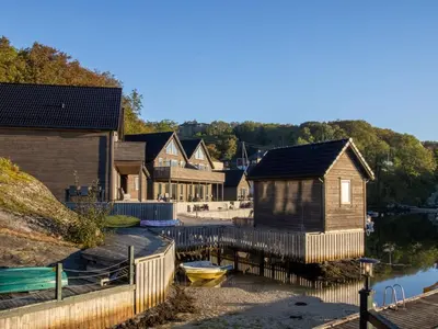 a group of houses and boats on the water at Holiday Home Nesjaholmen by Interhome in Kalavåg