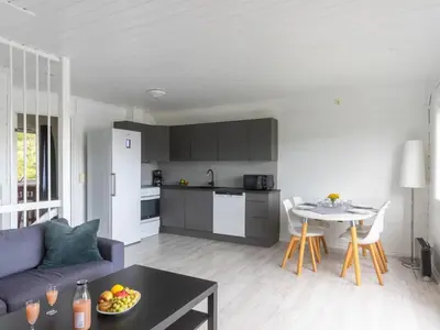 a living room with a couch and a table at Holiday Home Nesjaholmen by Interhome in Kalavåg