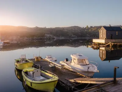 three boats are docked at a dock in the water at Holiday Home Pale by Interhome in Bømlo