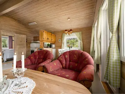 a dining room with two chairs and a table at Holiday Home Solbakken by Interhome in Gjølanger