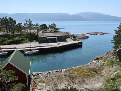 a house on a dock in a body of water at Holiday Home Nesjevik by Interhome in Bø
